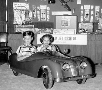 Spike Jones kids pose in the American Junior Jaguar car