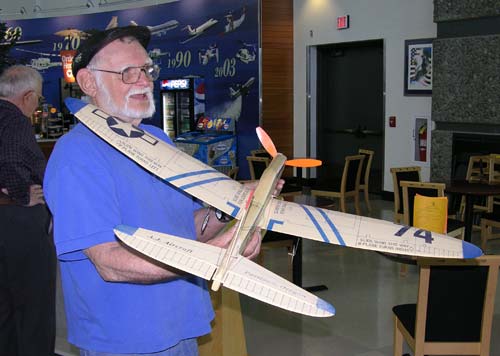 Gil Coughlin holds the radio controlled 74 Fighter built by Tex Newman